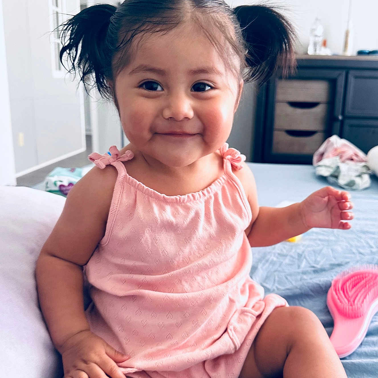 Sophia is registered to the contest to win money with this photo: baby, bed, casual, child, cute, dresser, furniture, hair, happy, indoor, person, pigtails, pink_outfit, portrait, room, sitting, skin, smile, toddler, toy