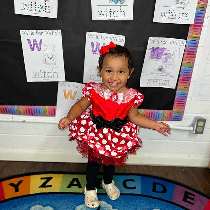 Phoebe is registered to the contest to win money with this photo: accessories, advertisement, child, clothing, costume, dress, face, female, footwear, girl, head, homedecor, indoors, person, photography, portrait, purple, shoe, sitting, skirt