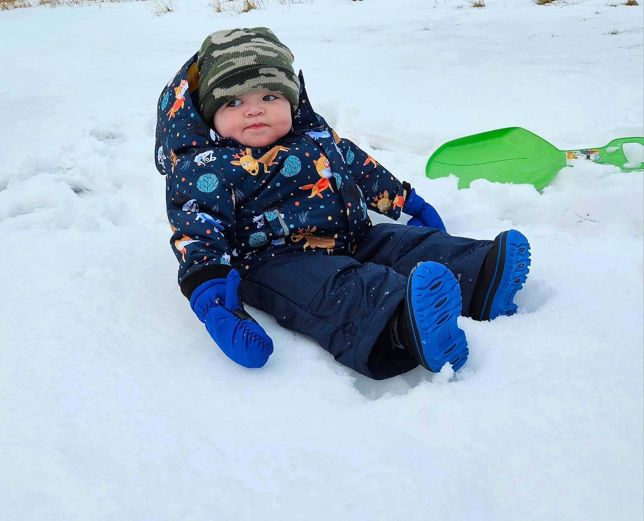 Isaac is registered to the contest to win money with this photo: comfort, electric_blue, freezing, fun, head, headwear, ice_cap, jacket, landscape, leisure, people_in_nature, person, play, recreation, sitting, sled, sledding, slope, snow, snow_boot