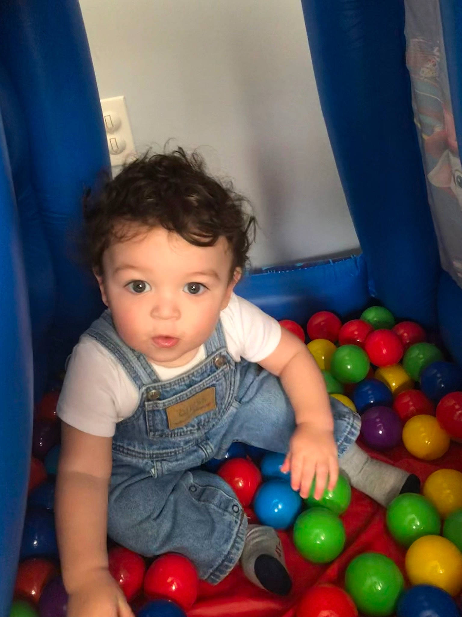Isaac is registered to the contest to win money with this photo: baby_toddler_clothing, ball, ball_pit, beauty, blue, child, facial_expression, fun, happy, leisure, organ, people, person, photograph, play, recreation, sitting, snapshot, surprise, toddler