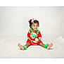 toddler, child, smiling, cupcake, red_dress, green_flower_accessories, flower_hair, curly_hair, studio, white_background, sitting, barefoot, happy, portrait, cute, food, celebration, isolated, indoors, person