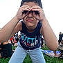 blue_shirt, boy, casual_clothing, child, crowd, daylight, event, fun, gesture, grass, happy, leisure, light_pants, nature, outdoor, people, picnic, playing, summer, young
