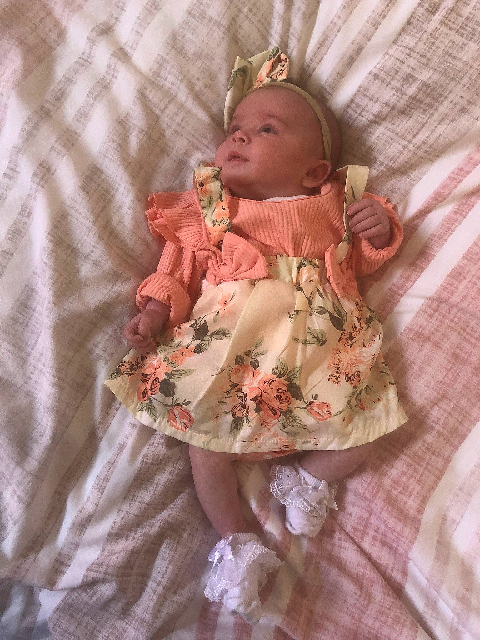 Alaska joined the competition — help win amazing prizes! baby, baby_products, baby_toddler_clothing, child, doll, dress, eye, fashion_accessory, hair_accessory, head, headgear, headpiece, linens, pattern, peach, person, sitting, sleeve, toddler, toy