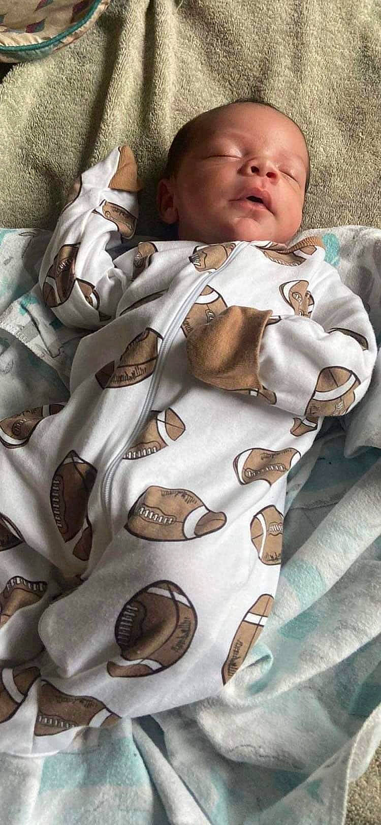 Braylen is registered to the contest to win money with this photo: baby, baby_products, baby_toddler_clothing, brown, cheek, child, collar, comfort, face, fashion_accessory, fashion_design, fur, jacket, linens, pattern, person, sleeve, textile, toddler, uniform