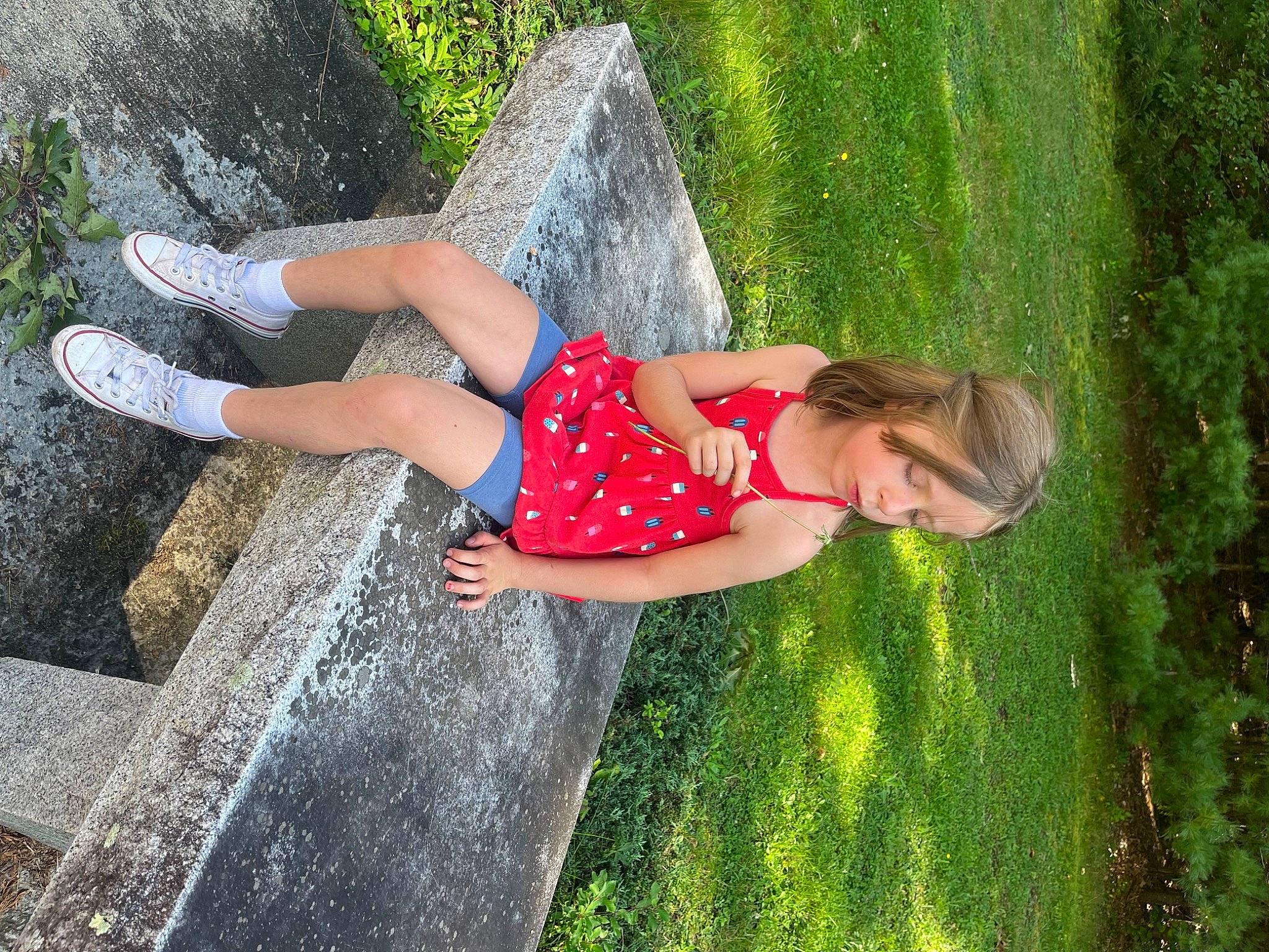 Evelyn is registered to the contest to win money with this photo: child, flash_photography, fun, garden, grass, grass_family, green, happy, human_leg, landscape, leisure, people_in_nature, person, plant, recreation, shrub, sitting, t_shirt, thigh, tree