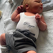 Reggie joined the competition — help win amazing prizes! baby, bed, bedroom, blanket, clothing, face, furniture, glove, head, newborn, pants, person, photography, portrait, quilt, shorts, skin, sleeping, t_shirt, tattoo