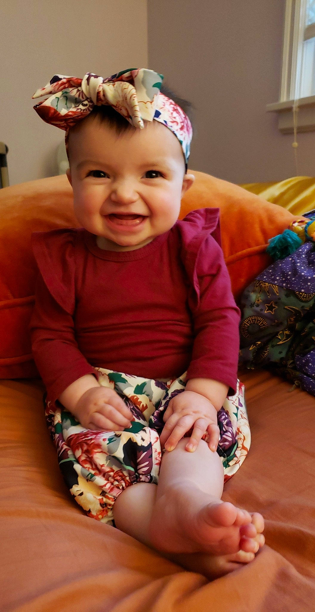 Luciana is registered to the contest to win money with this photo: baby, baby_toddler_clothing, cheek, child, comfort, dress, eye, face, finger, happy, head, human_body, iris, leg, mammal, person, pink, skin, sleeve, smile