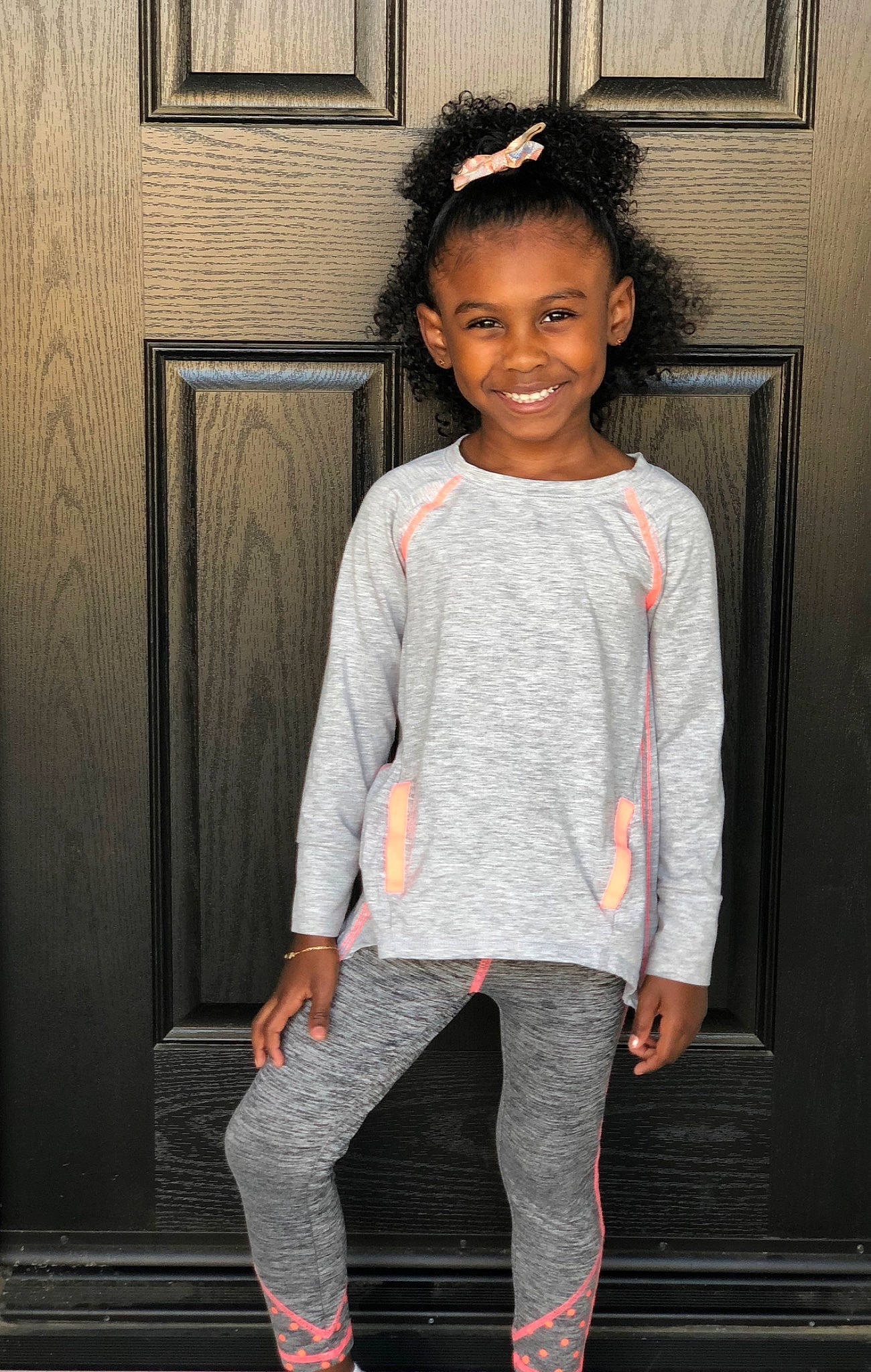 Casey is registered to the contest to win money with this photo: active_pants, child, child_model, clothing, fashion, footwear, jeans, joy, leggings, neck, outerwear, person, shoe, shoulder, sleeve, smile, sportswear, standing, sweatpant, t_shirt