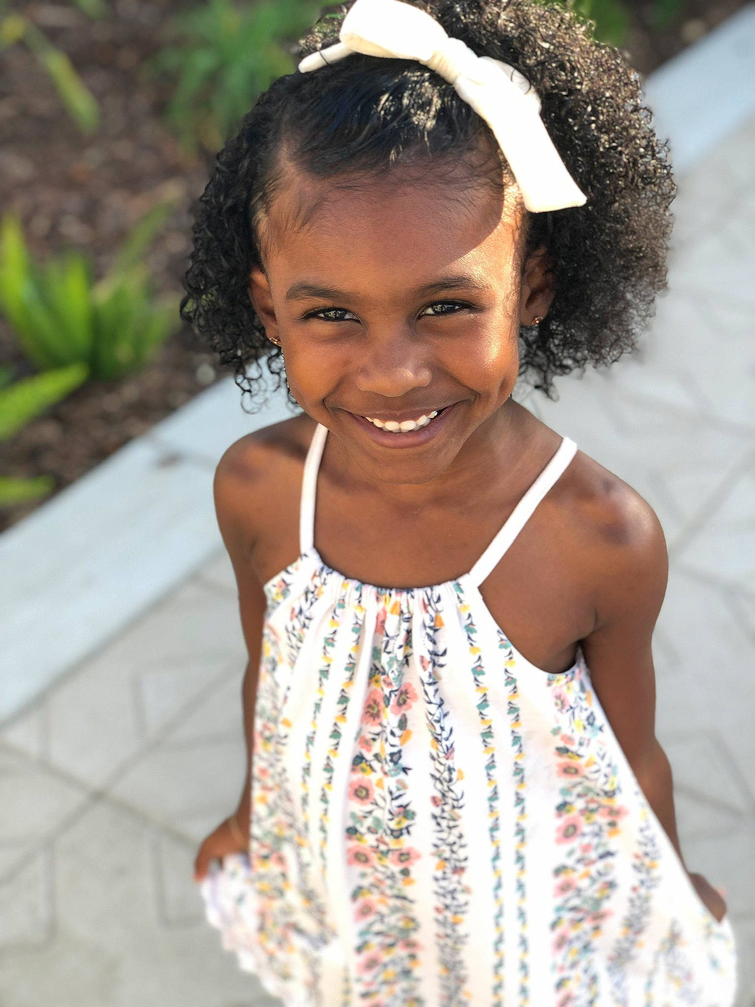 Casey is registered to the contest to win money with this photo: beauty, black_hair, child, child_model, dress, fashion_accessory, hair, hair_accessory, headband, headgear, joy, pattern, person, smile, toddler, white