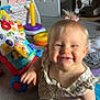 Hailey joined the competition — help win amazing prizes! toddler, baby, child, smiling, indoor, toy, playroom, colorful, rocking_horse, ring_stack, carpet, quilt, dress, blond_hair, face, hand, foot, cheerful, cute, happy