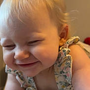 Hailey joined the competition — help win amazing prizes! baby, child, smiling, happy, face, hair_bow, blonde_hair, cute, ruffled_clothing, flower_pattern, infant, portrait, closeup, indoor, skin, cheeks, person, young_child, playful, joyful