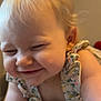 baby, child, smiling, happy, face, hair_bow, blonde_hair, cute, ruffled_clothing, flower_pattern, infant, portrait, closeup, indoor, skin, cheeks, person, young_child, playful, joyful
