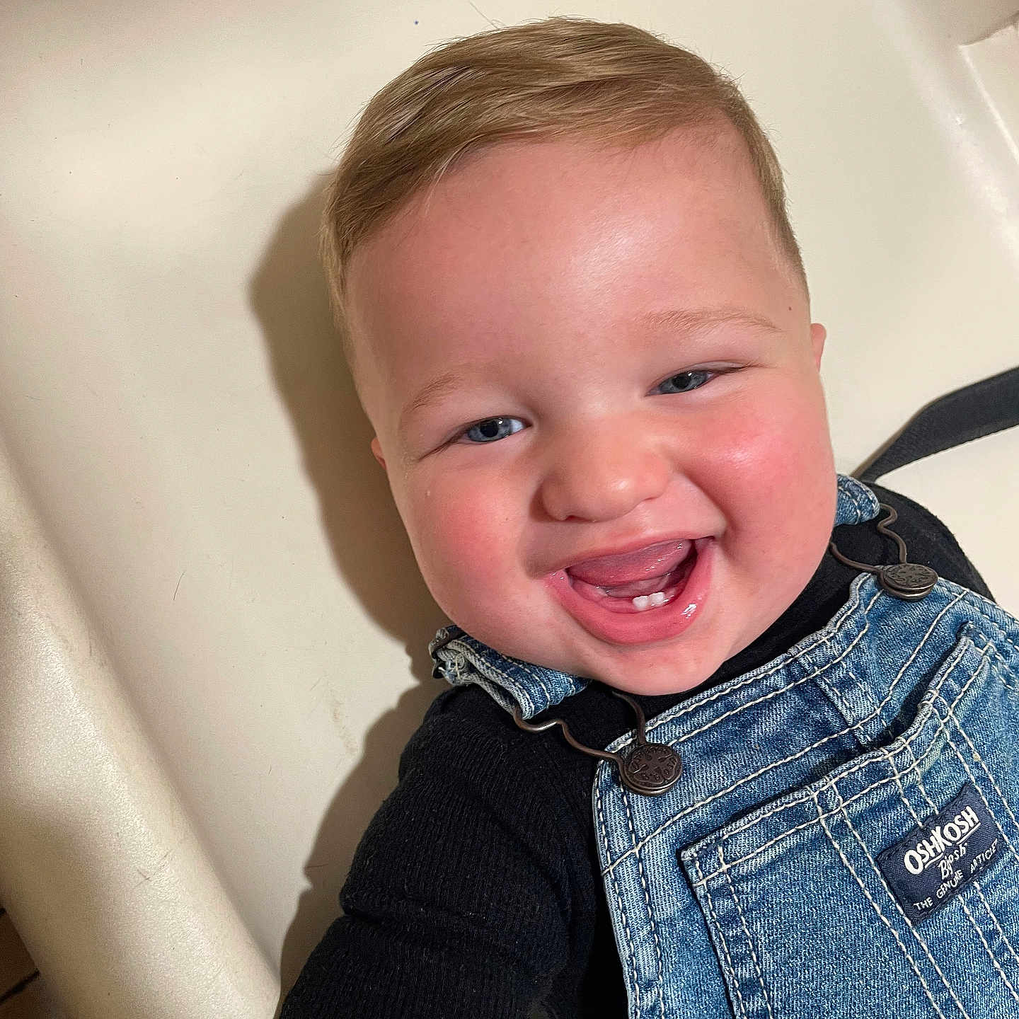 Xander joined the competition — help win amazing prizes! baby, child, smiling, laughing, denim_overalls, black_shirt, face, blue_eyes, rosy_cheeks, teeth, bathtub, bathroom, happy, cute, portrait, infant, young_child, clothing, indoors, person