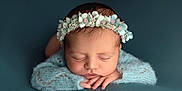 Adhara participe au concours pour gagner de l'argent avec cette photo : newborn, baby, sleeping, flower_crown, headband, blue, knitted, soft, peaceful, portrait, infant, cute, resting, closeup, hands, face, young_child, studio, cozy, calm