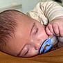 Adhara participe au concours pour gagner de l'argent avec cette photo : baby, sleeping, pacifier, closeup, face, hand, infant, resting, cozy, soft_lighting, eyelashes, skin, peaceful, indoor, child, person, cute, comfort, young, portrait