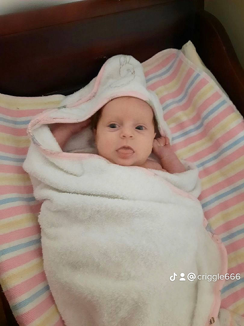 Saphira is registered to the contest to win money with this photo: baby, baby_products, baby_toddler_clothing, bedding, cap, cheek, child, comfort, couch, eye, happy, hat, headwear, linens, pattern, person, portrait_photography, room, sitting, sleeve