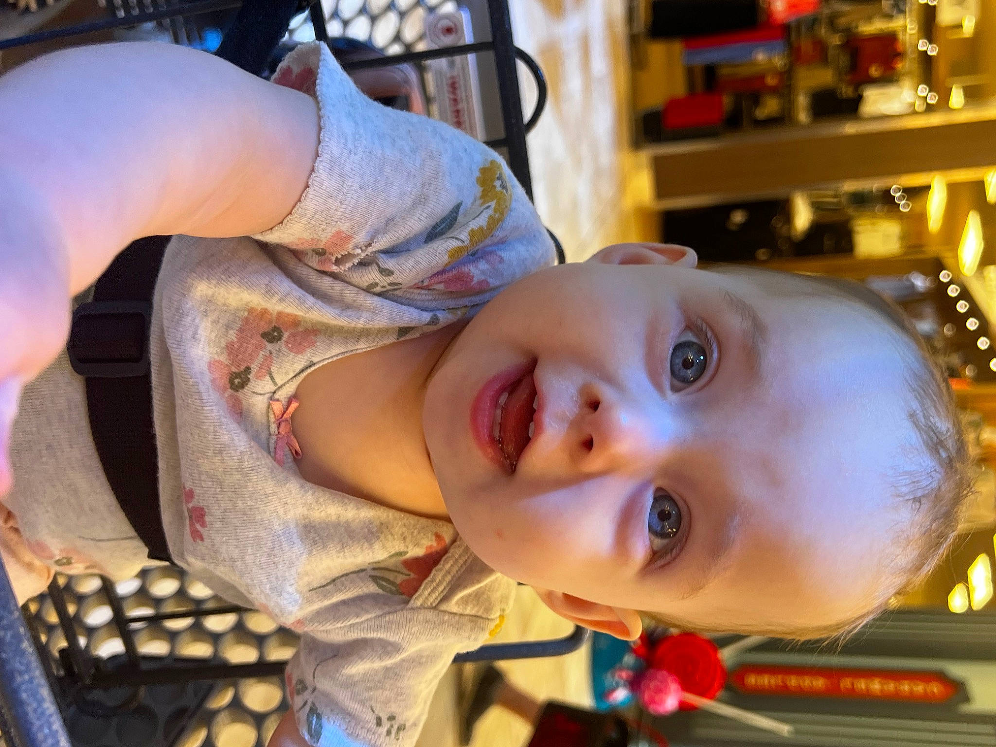 Evelynn joined the competition — help win amazing prizes! baby, baby_toddler_clothing, cheek, child, ear, eye, eyelash, fun, happy, iris, mouth, nose, organ, pattern, person, room, shelf, sitting, smile, toddler
