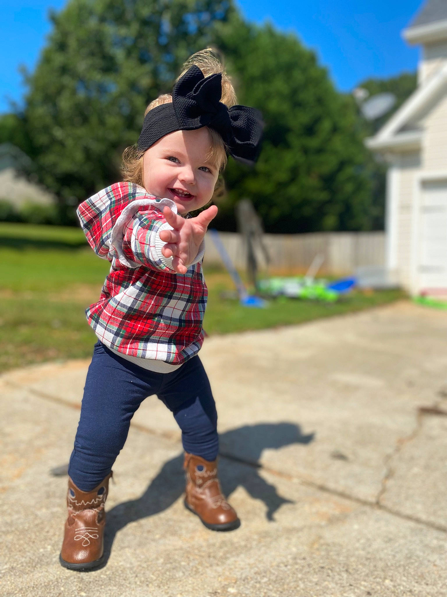 Iris is registered to the contest to win money with this photo: baby, fun, grass, hand, happy, hat, headwear, joy, leisure, people_in_nature, person, plaid, plant, recreation, shoe, sky, sleeve, smile, sneakers, sun_hat
