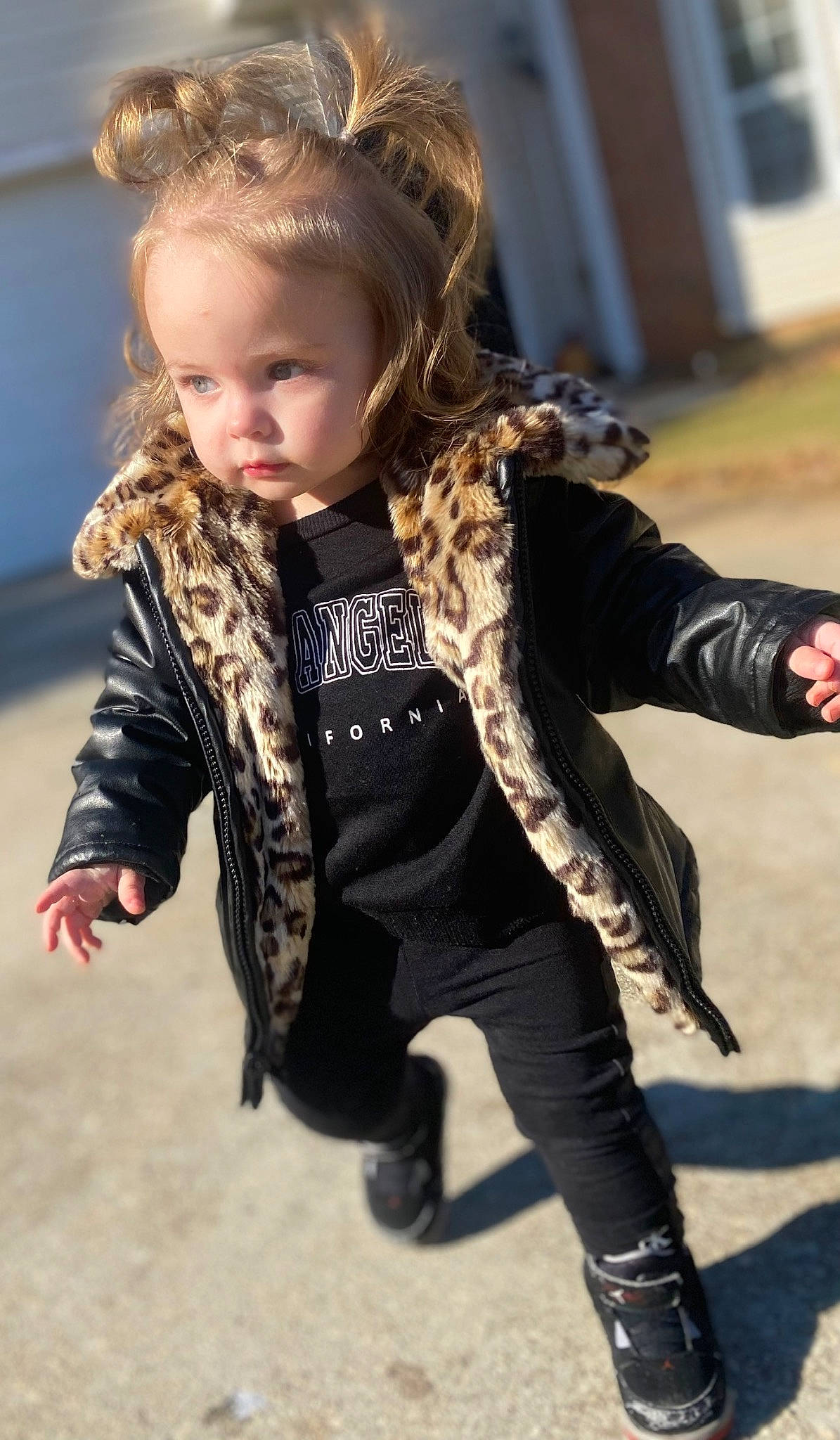 Iris is registered to the contest to win money with this photo: blond, brown_hair, fashion_accessory, fashion_design, fur, hair, happy, head, human_leg, knee, leather_jacket, leggings, long_hair, pattern, person, scarf, sitting, sleeve, thigh, toddler
