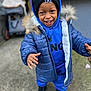child, toddler, boy, smile, hoodie, beanie, jacket, fur_trim, blue_clothing, outdoor, portrait, hands, teeth, warm_clothing, shoes, concrete, stroller, playful, happy, closeup
