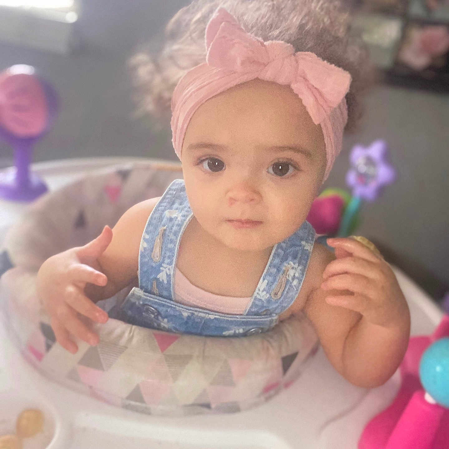 Leinani joined the competition — help win amazing prizes! activity_center, baby, child, colorful, curly_hair, cute, denim_overalls, exploring, expression, face, hands, headband, indoor, natural_light, pink, play, toddler, toy, window_light, young_child