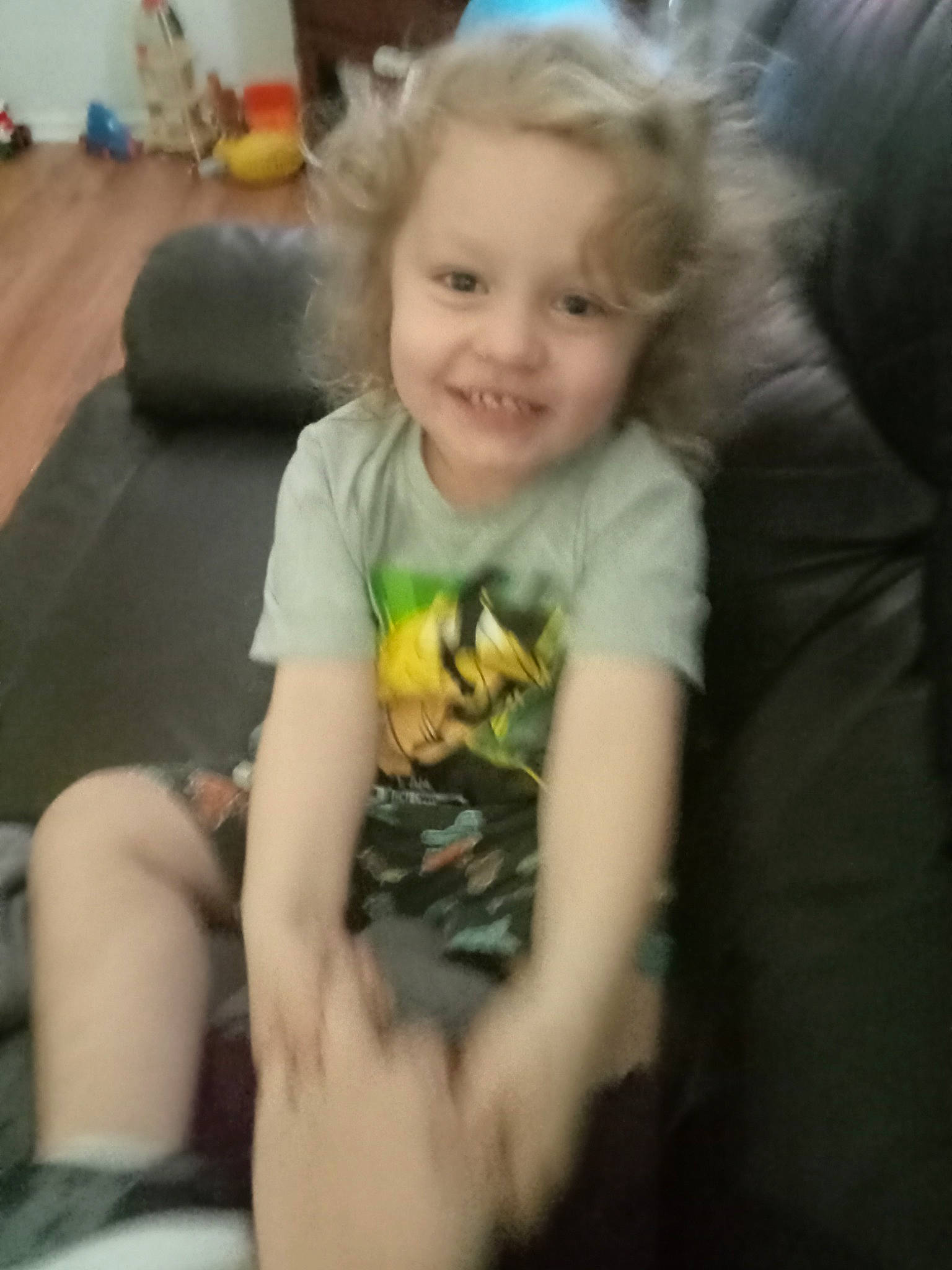 Jaxon is registered to the contest to win money with this photo: baby, baby_toddler_clothing, cheek, child, comfort, cool, couch, electronic_device, eye, fun, happy, human_leg, iris, joy, mouth, person, sitting, smile, t_shirt, thigh