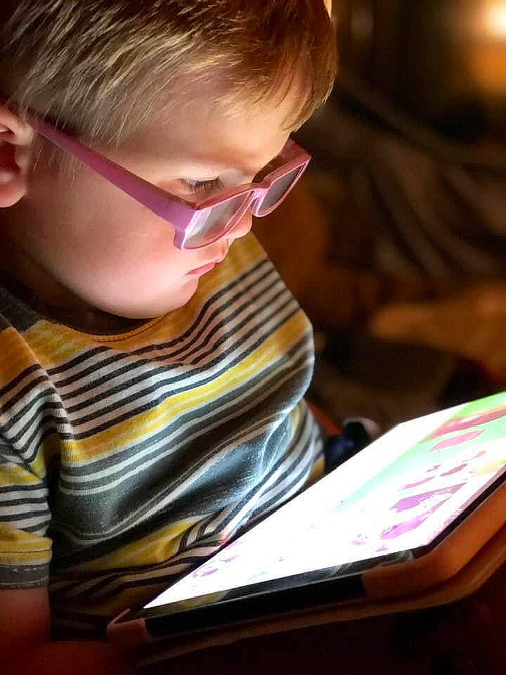 Conner joined the competition — help win amazing prizes! beauty, child, curious, electronic_device, eyewear, fun, gadget, glasses, goggles, homework, human, office_equipment, office_supplies, person, reading, sitting, snapshot, t_shirt, toddler, vision_care