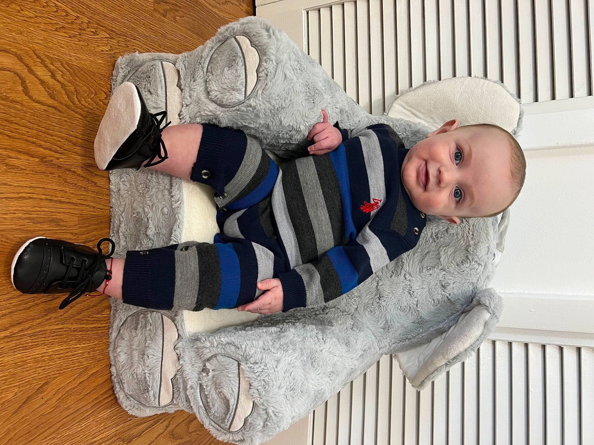 Wyatt is registered to the contest to win money with this photo: baby, baby_products, baby_safety, baby_sleeping, baby_toddler_clothing, child, comfort, fence, flooring, fur, hardwood, pattern, person, room, sitting, sleeve, toddler, white, wood, wool