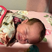 Allison is registered to the contest to win money with this photo: baby, newborn, sleeping, blanket, floral, pacifier, face, infant, bed, cute, young, child, portrait, resting, soft, smile, indoors, peaceful, wrapped, comfort