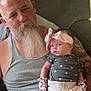 elderly_man, baby, beard, headband, mittens, polka_dot, tank_top, tattoo, couch, indoor, holding, infant, pink, white_pants, gray_shirt, portrait, family, seated, cute, cozy