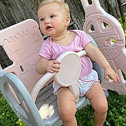 Everleigh joined the competition — help win amazing prizes! toddler, child, outdoor, swing, playground, grass, pink_clothing, baby, seat, fence, summer, cute, play, nature, person, plastic, sunlight, happy, garden, young