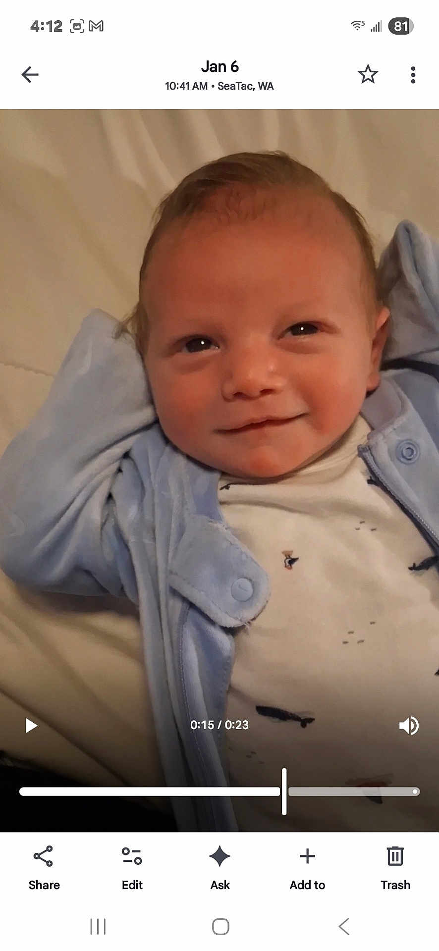 Jameson is registered to the contest to win money with this photo: baby, infant, smile, face, blue_jacket, white_shirt, lying_down, closeup, child, cute, relaxed, cozy, indoors, portrait, small_prints, skin, hair, expression, young, person