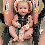 Paisley joined the competition — help win amazing prizes! baby, car_seat, bottle, mittens, pink, blue_eyes, floor, person, infant, seatbelt, wooden_floor, clothing, cute, bottle_nipple, child, baby_bottle, sitting, indoors, face, portrait