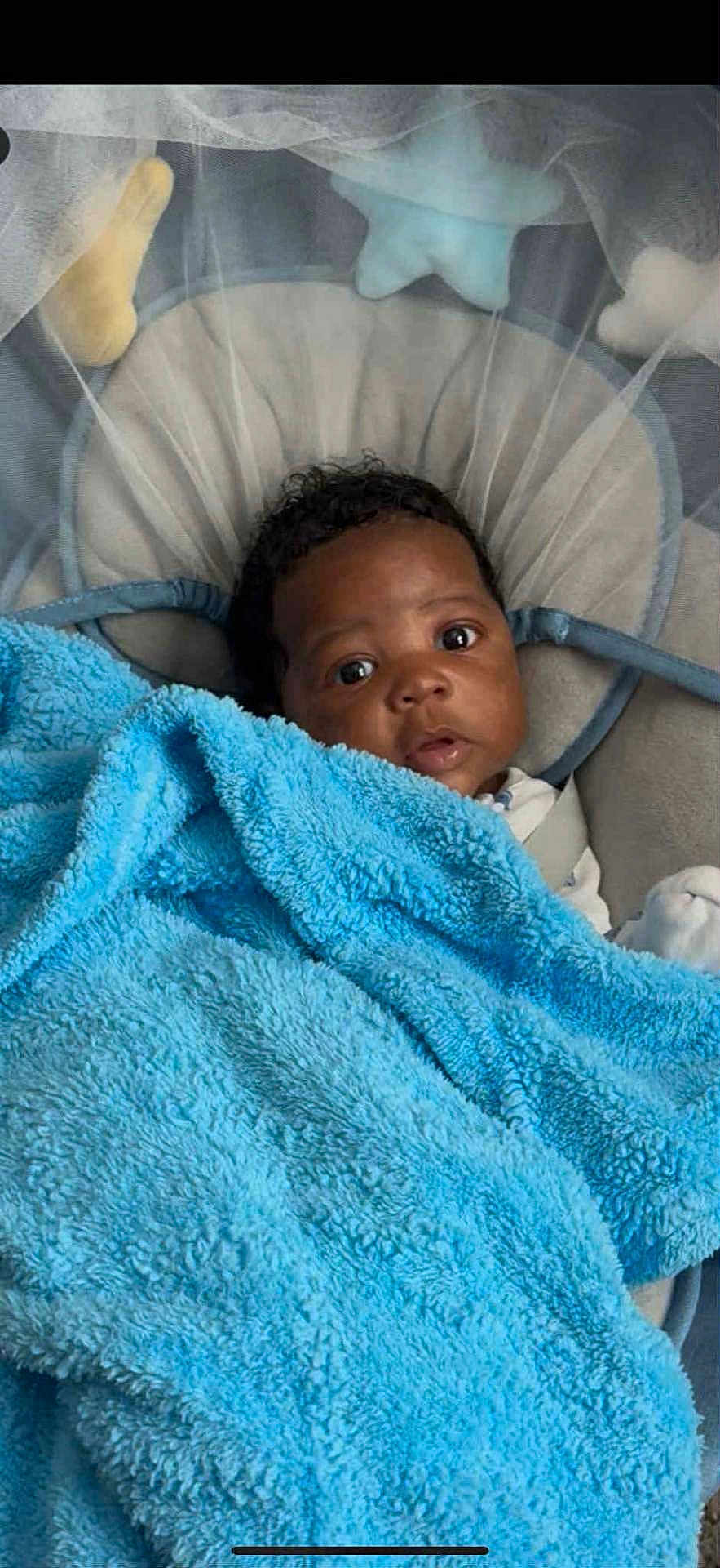 Destin joined the competition — help win amazing prizes! baby, blanket, blue, cushion, infant, face, eyes, seat, soft_toys, star, curious, child, indoors, comfort, cozy, portrait, wrapped, cute, young, resting