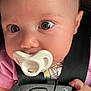 baby, infant, pacifier, car_seat, child, face, hand, clothing, pink, closeup, young_child, sitting, seatbelt, cute, curious, portrait, indoor, human, person, newborn