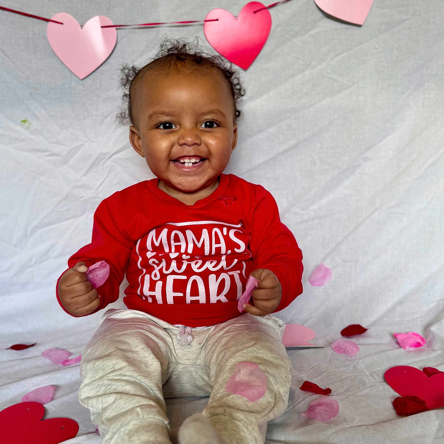 Noah joined the competition — help win amazing prizes! baby, bodypart, clothing, face, finger, flower, hand, happy, head, heart, pants, person, petal, photography, plant, portrait, sitting, smile, symbol, t_shirt