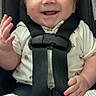 Andrew is registered to the contest to win money with this photo: baby, smiling, car_seat, child, infant, safety_harness, clothing, happy, cute, waving, seat_belt, striped_shorts, patterned_shirt, indoor, portrait, person, young_child, face, hand, seat