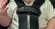 Andrew is registered to the contest to win money with this photo: baby, child, car_seat, smiling, happy, safety_harness, infant, cute, portrait, clothing, hand, seatbelt, young_child, indoors, person, face, sitting, casual, closeup, expression