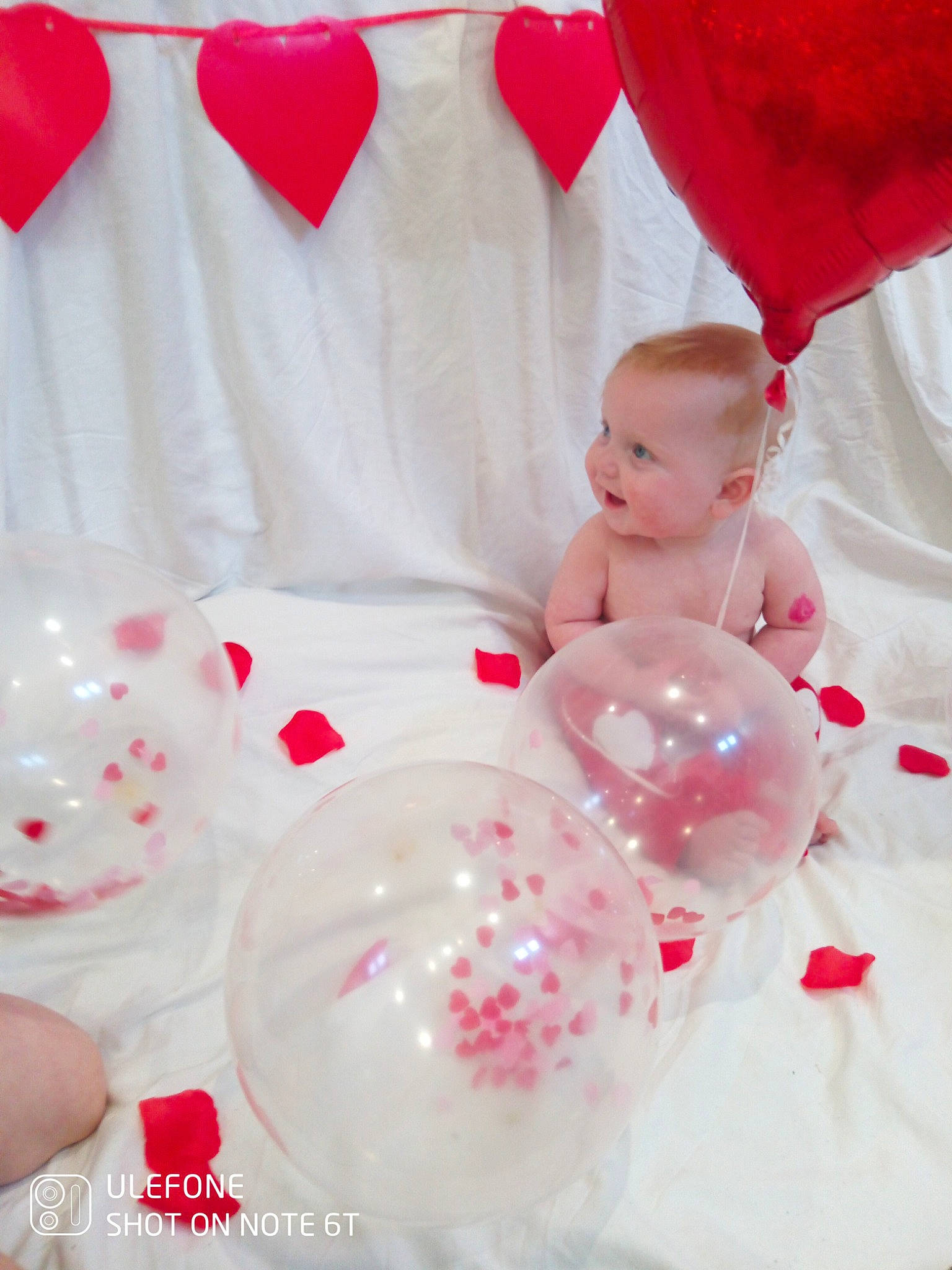 Ares is registered to the contest to win money with this photo: baby, baby_products, baby_toddler_clothing, carmine, child, dress, drinkware, event, happy, linens, magenta, party_supply, pattern, peach, person, petal, pink, red, sweetness, textile