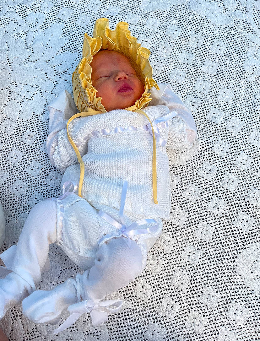 Beatrice is registered to the contest to win money with this photo: art, baby_toddler_clothing, child, craft, crochet, doll, dress, electric_blue, fashion_accessory, fashion_design, fur, linens, pattern, person, room, sitting, textile, toy, wig, wool