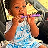 toddler, child, car, car_seat, nike, clothing, blue, white, sitting, curious, holding, object, shorts, tshirt, indoors, window, daylight, hair, person, footwear