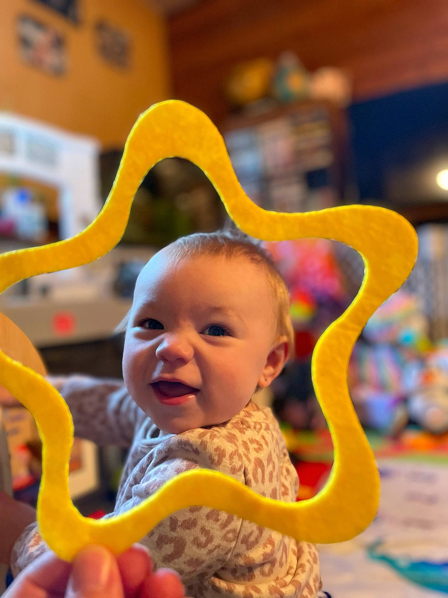 Melody is registered to the contest to win money with this photo: baby, baby_products, baby_toddler_clothing, child, event, face, fun, happy, hat, laugh, leisure, person, play, sitting, smile, toddler, vacation, yellow