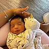 Mavie Ocean joined the competition — help win amazing prizes! baby, sleeping, infant, plush_toy, unicorn, hand, bracelet, clothing, indoors, soft_lighting, comfort, cuddle, peaceful, person, fabric, toy, closeup, rest, cute, child