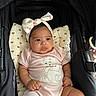 Mavie Ocean joined the competition — help win amazing prizes! baby, infant, child, stroller, onesie, headband, bow, cartoon, pink_clothing, pillow, heart_pattern, cute, indoors, relaxed, chubby, skin, hand, face, legs, seated