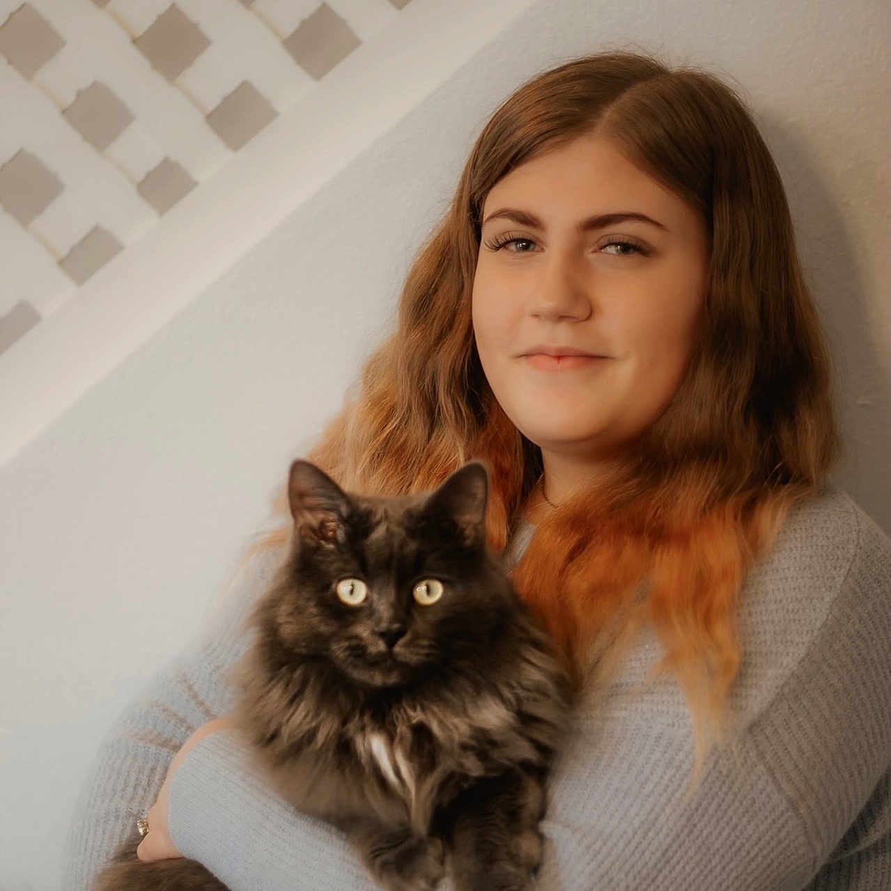 Smokey is registered to the contest to win money with this photo: animal, bond, cat, cozy, cute, face, feline, fluffy_cat, gray_sweater, holding, indoor, long_hair, neutral_background, omre_hair, pet, portrait, smile, warm_lighting, wavy_hair, woman