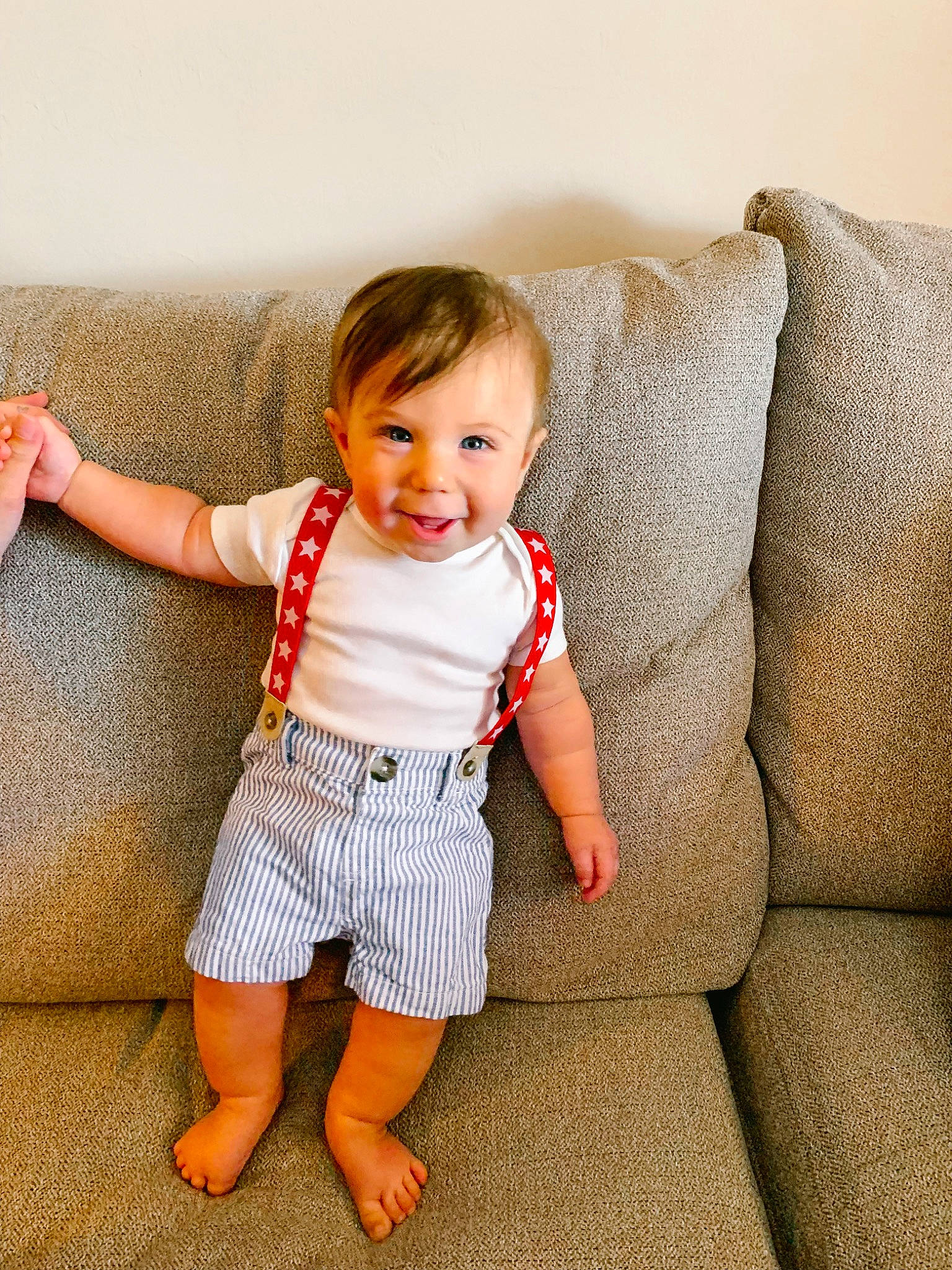 Levi is registered to the contest to win money with this photo: baby_toddler_clothing, child, comfort, couch, face, facial_expression, hairstyle, happy, human_body, human_leg, joy, knee, person, rectangle, sitting, skin, sleeve, smile, t_shirt, textile