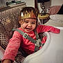 toddler, child, high_chair, crown, smiling, happy, pink_clothing, straps, indoor, lamp, table, furniture, home, cute, person, baby, seat, reaching, cozy, portrait