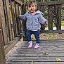 Kaëly a rejoint le concours — aidez-le/la à gagner de superbes lots ! toddler, child, outdoor, wooden_deck, sweater, pink_socks, autumn_leaves, railing, nature, trees, curious, standing, baby, person, fall, greenery, exploring, young_child, wood, casual_clothing