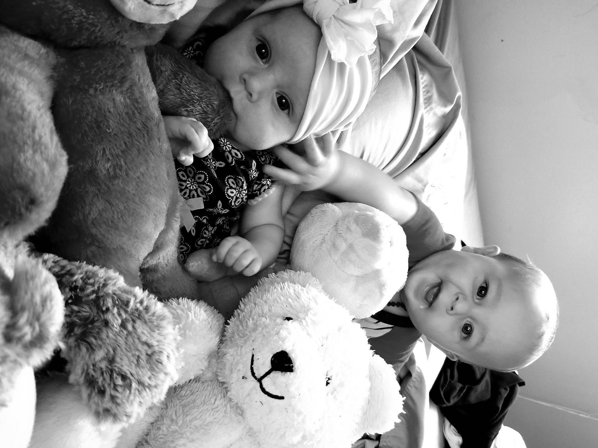 Charlene is registered to the contest to win money with this photo: baby, black_and_white, child, headwear, monochrome, monochrome_photography, person, photograph, photography, portrait_photography, smile, stock_photography, stuffed_toy, style, teddy_bear, toddler, toy