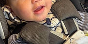 Ke-Shawn joined the competition — help win amazing prizes! baby, blanket, car_seat, child, closeup, comfort, cozy, curly_hair, cute, eyes, face, happy, indoors, infant, person, portrait, safety_harness, seatbelt, smiling, striped_clothing